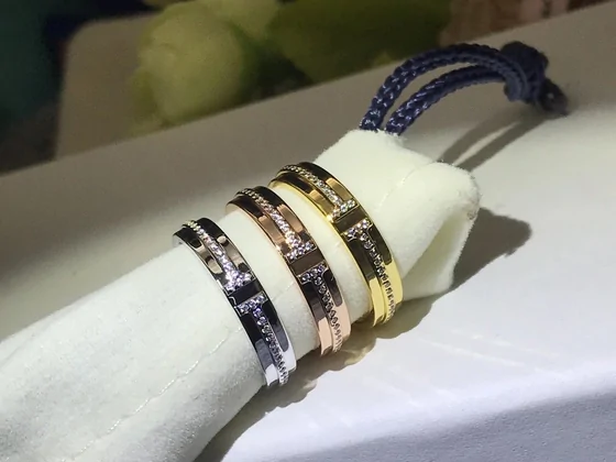 Stacked bangles in silver, gold and rose tones on a white cloth
