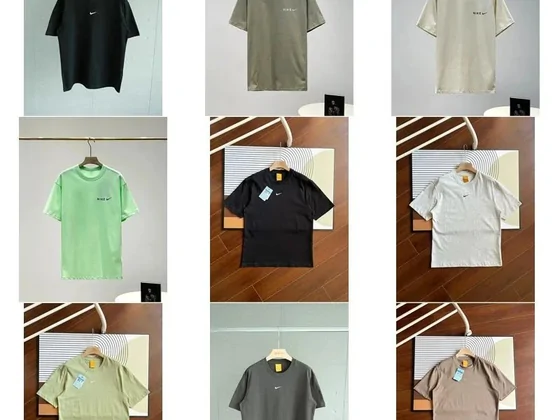 Plain T-shirts on wooden hangers in black, sage, sand and grey