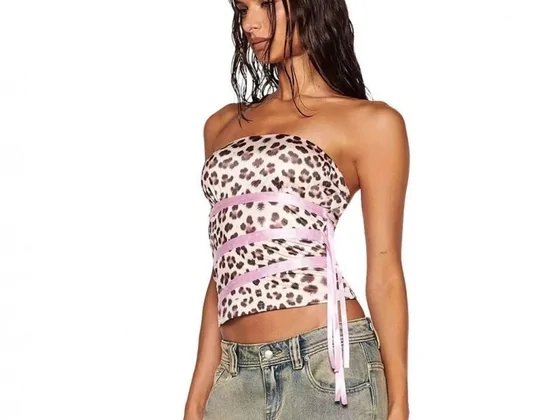 A model wearing a strapless leopard-print top with a pink ribbon tie
